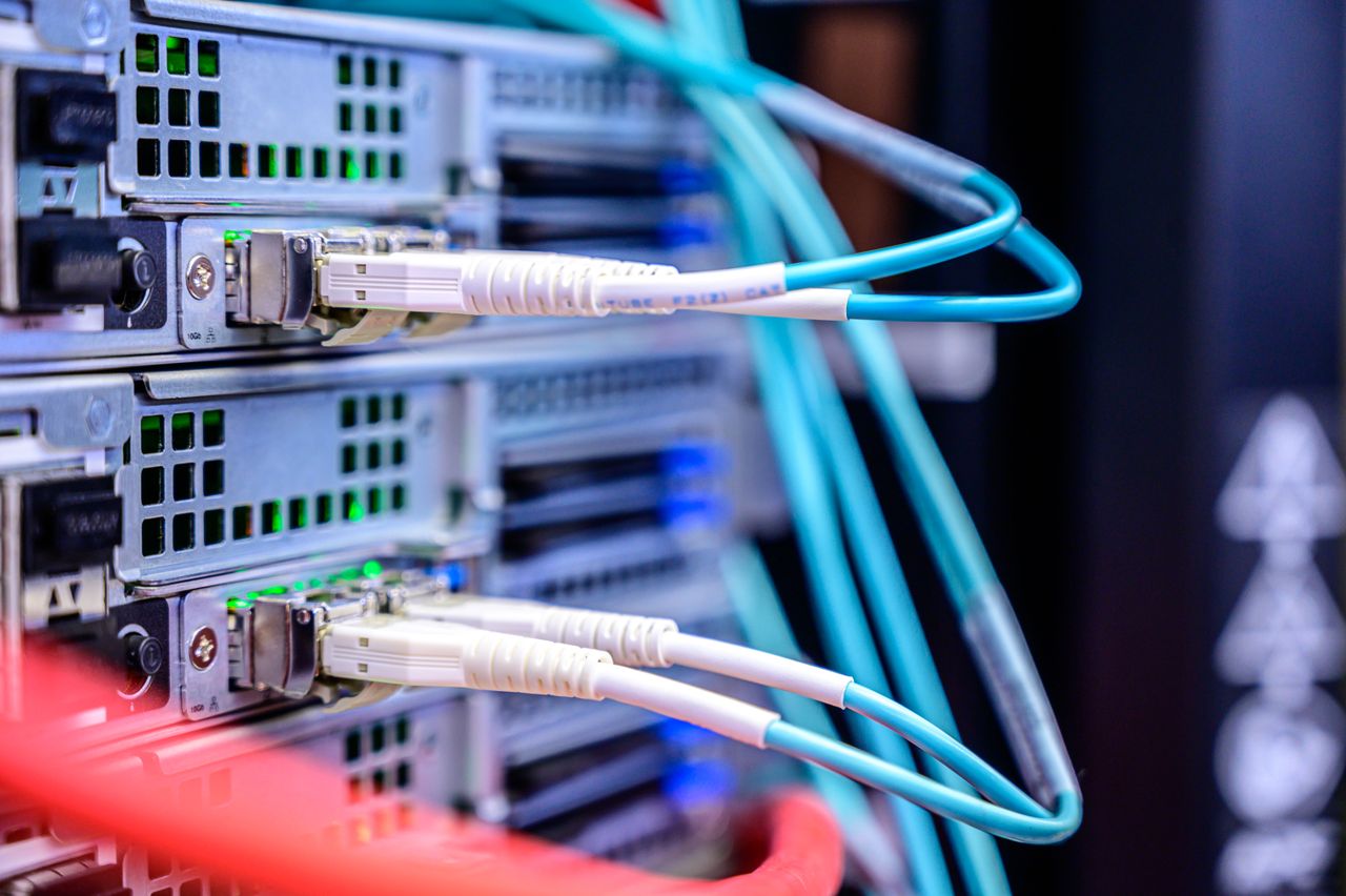 services-01 Detailed shot of Ethernet cables connected to server ports highlighting technology infrastructure.