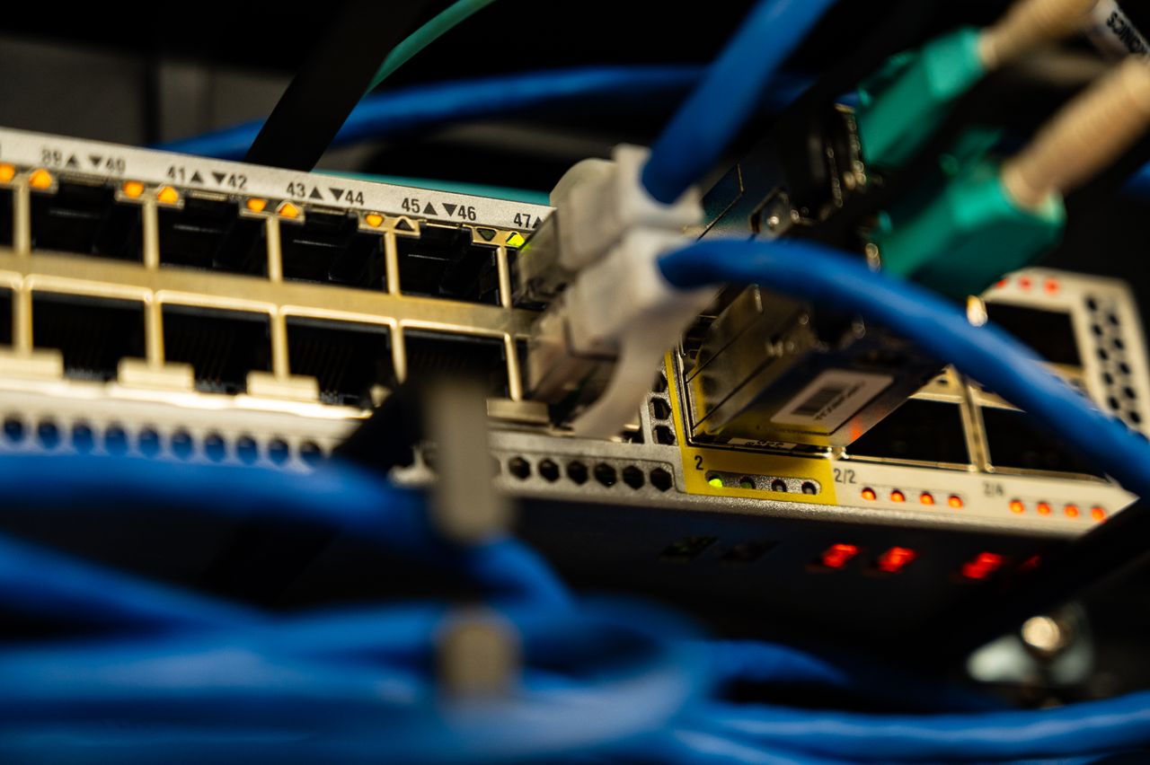 Mastering the First Impression: Your intriguing post title goes here Close-up image of ethernet cables plugged into a network switch, showcasing IT infrastructure.
